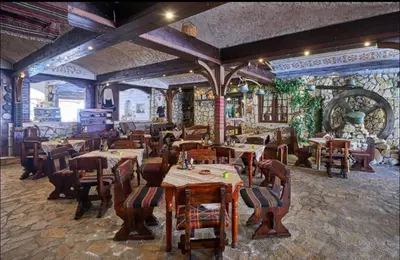 a restaurant with tables and chairs in a room at Апартаменты с одной спальней Carolina in Sunny Beach