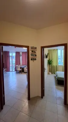 a room with two doors and a room with a bedroom at Апартаменты с одной спальней Carolina in Sunny Beach