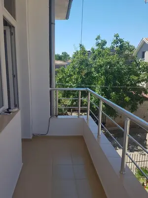 a balcony of a building with a railing at Къща за гости Ани in Chernomorets