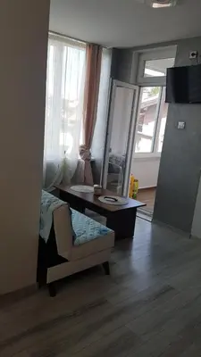 a bedroom with a desk and a chair and a mirror at Къща за гости Ани in Chernomorets