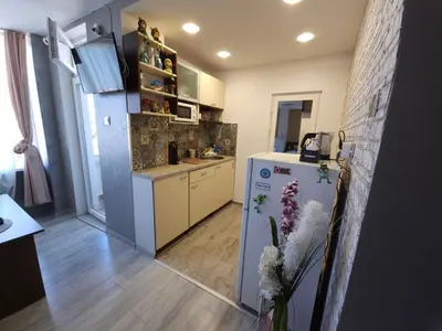 a kitchen with a refrigerator and a counter at Къща за гости Ани in Chernomorets