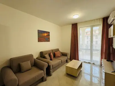 a living room with two couches and a window at HORIZON 18 'Б' Apartment Sveti Vlas in Sveti Vlas
