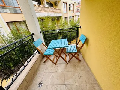 a table and two chairs sitting on a balcony at HORIZON 17 'Б' Apartment Sveti Vlas in Sveti Vlas