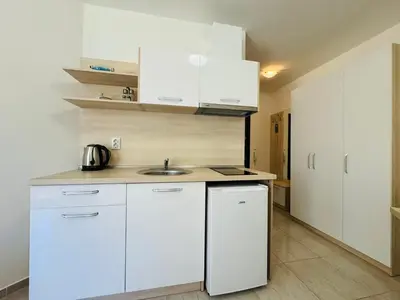 a kitchen with white cabinets and a sink at HORIZON 11 'Б' Studio Sveti Vlas in Sveti Vlas