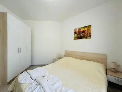 a bedroom with a bed and a painting on the wall at HORIZON 10 'Б' Apartment Sveti Vlas in Sveti Vlas
