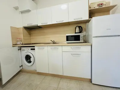 a kitchen with a white refrigerator and a microwave at HORIZON 10 'Б' Apartment Sveti Vlas in Sveti Vlas