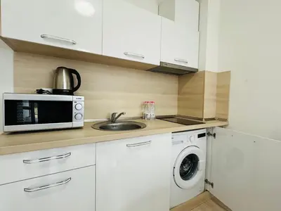 a kitchen with a sink and a microwave at HORIZON 9 'Б' Apartment Sveti Vlas in Sveti Vlas