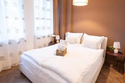 a bedroom with a white bed with a basket on it at Seaside Estate - Cozy and Romantic - Public Parking Nearby in Varna City