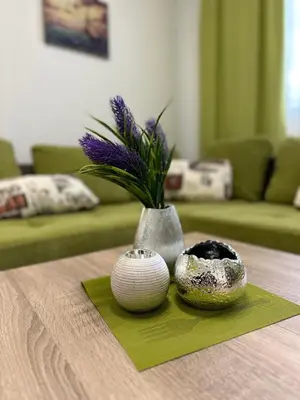 a table with a vase and two bowls on a table at Апартамент 
