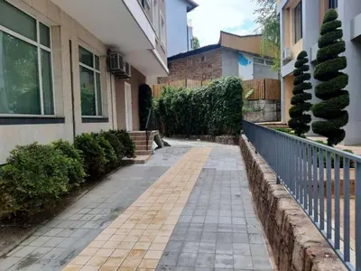 a walkway in front of a house with a fence at Апартамент 
