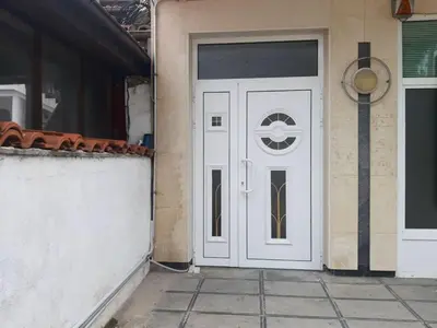 a white door on the side of a building at Апартамент 
