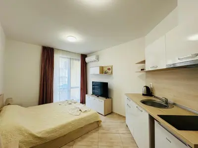 a small room with a bed and a sink in it at HORIZON 33 'Б' Studio Sveti Vlas in Sveti Vlas