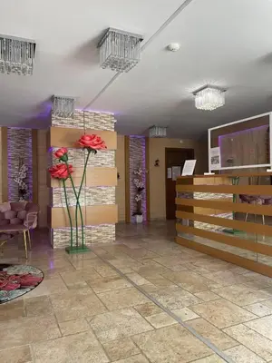 a lobby with flowers in a vase in a room at Sweety SP apartments in Sunny Beach