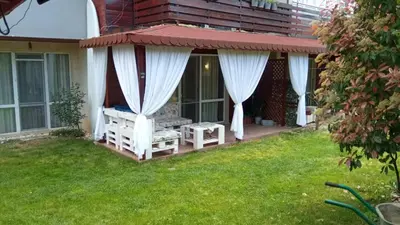 a porch with a gazebo with white curtains at Sea Salt Suite- Sozopol in Sozopol
