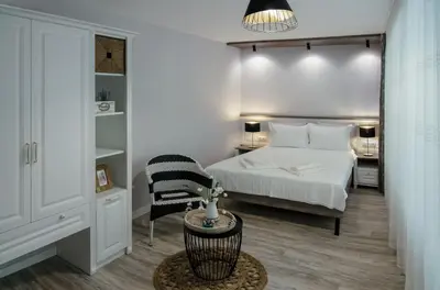 a small bedroom with a bed and a chair at Apartment Bellissima 2 minutes away from the beach in Nesebar