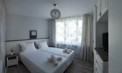 a bedroom with a bed with two towels on it at Apartment Bellissima 2 minutes away from the beach in Nesebar