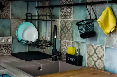 a kitchen sink with a mirror on the wall at Apartment Bellissima 2 minutes away from the beach in Nesebar