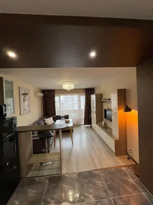 a living room with a table and a dining room at Tei-Zi apartments in Burgas City