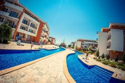 a swimming pool in front of some buildings at Привилидж первая линия in Sveti Vlas