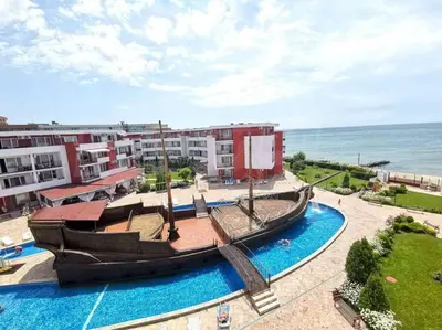 a large boat in a pool next to some buildings at Привилидж первая линия in Sveti Vlas