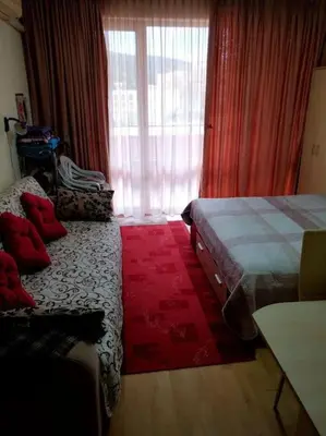 a hotel room with two beds and a window at Привилидж первая линия in Sveti Vlas