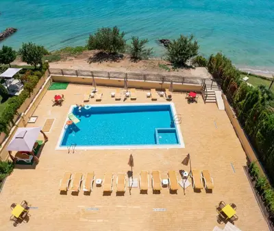 an overhead view of a swimming pool with chairs and the ocean at HORIZON 34 'В' Apartment Sveti Vlas in Sveti Vlas
