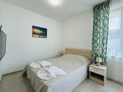 a bedroom with a bed with towels on it at HORIZON 28 'В' Apartment Sveti Vlas in Sveti Vlas