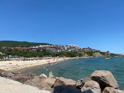 a beach with a group of people in the water at HORIZON 27 'В' Studio Sveti Vlas in Sveti Vlas