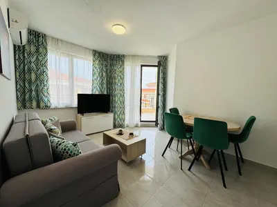 a living room with a couch and a table at HORIZON 26 'В' Apartment Sveti Vlas in Sveti Vlas