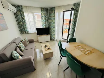 a living room with a couch and a table at HORIZON 26 'В' Apartment Sveti Vlas in Sveti Vlas