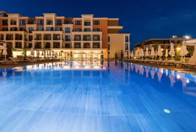 a large swimming pool in front of a building at Premier Fort Apartment on Seafront in Sveti Vlas