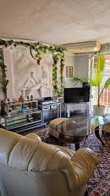 a living room with a couch and a table at Хоризонт in Nesebar