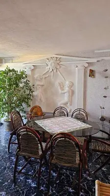 a dining room with a table and chairs at Хоризонт in Nesebar