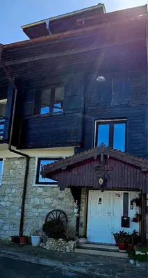 a house with a red roof and a white door at Хоризонт in Nesebar