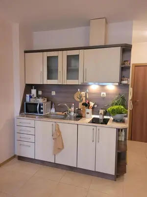 a kitchen with white cabinets and a sink at ALMA DEL MAR - Miadia Grand Resort, Aheloy in Aheloy