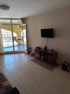 a living room with a flat screen tv on a wall at ALMA DEL MAR - Miadia Grand Resort, Aheloy in Aheloy