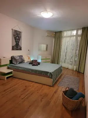 a bedroom with a bed and a chair in it at ALMA DEL MAR - Miadia Grand Resort, Aheloy in Aheloy
