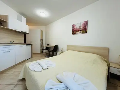 a bedroom with a bed with two towels on it at HORIZON 11 'В' Studio Sveti Vlas in Sveti Vlas