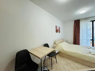 a bedroom with a bed and a table and chairs at HORIZON 11 'В' Studio Sveti Vlas in Sveti Vlas