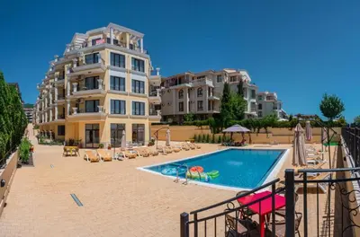 a hotel with a swimming pool next to a building at HORIZON 10 'В' Apartment Sveti Vlas in Sveti Vlas