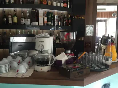 a kitchen counter with a blender on a shelf at Milano Hotel in Burgas City