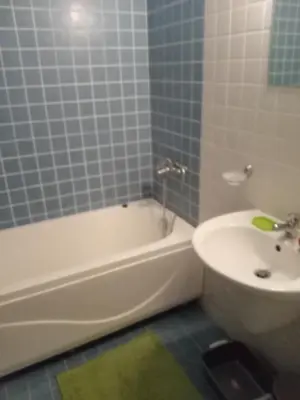 a bathroom with a tub and a toilet and a sink at Клара in Burgas City