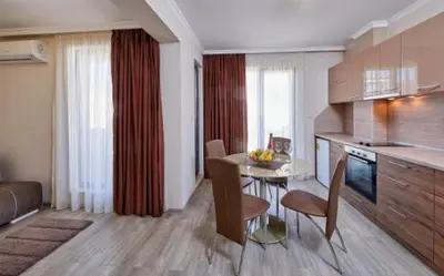 a kitchen with a table and chairs in a room at Bendita House in Pomorie