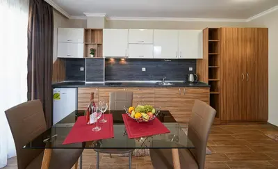 a kitchen with a glass table with a bowl of fruit at Bendita House in Pomorie