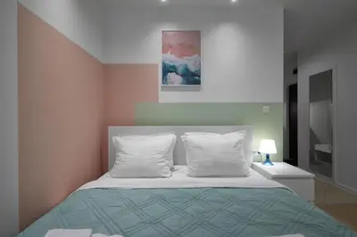 a bedroom with a bed with two pillows at Sea Moreto Studio 1 in Burgas City
