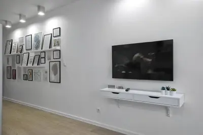 a white room with a tv on a white wall at Sea Moreto Studio 1 in Burgas City