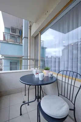 a small table and two chairs on a balcony at Sea Moreto Studio 1 in Burgas City