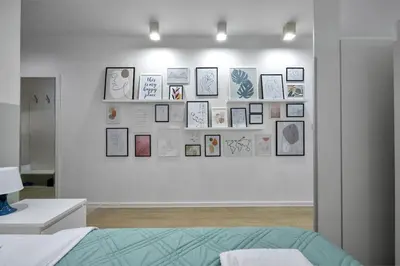 a room with a wall with pictures on it at Sea Moreto Studio 1 in Burgas City