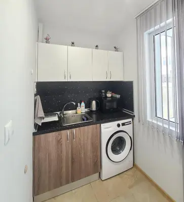 a kitchen with a sink and a washing machine at Downtown Apartment Varna in Varna City