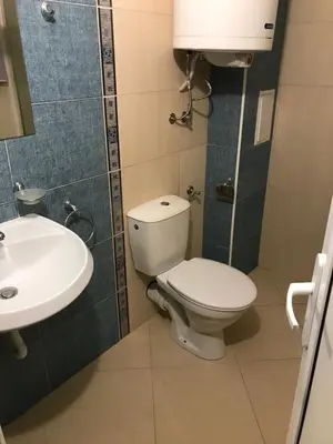 a bathroom with a toilet and a sink at Summer Rose Studio by the Sea in Byala